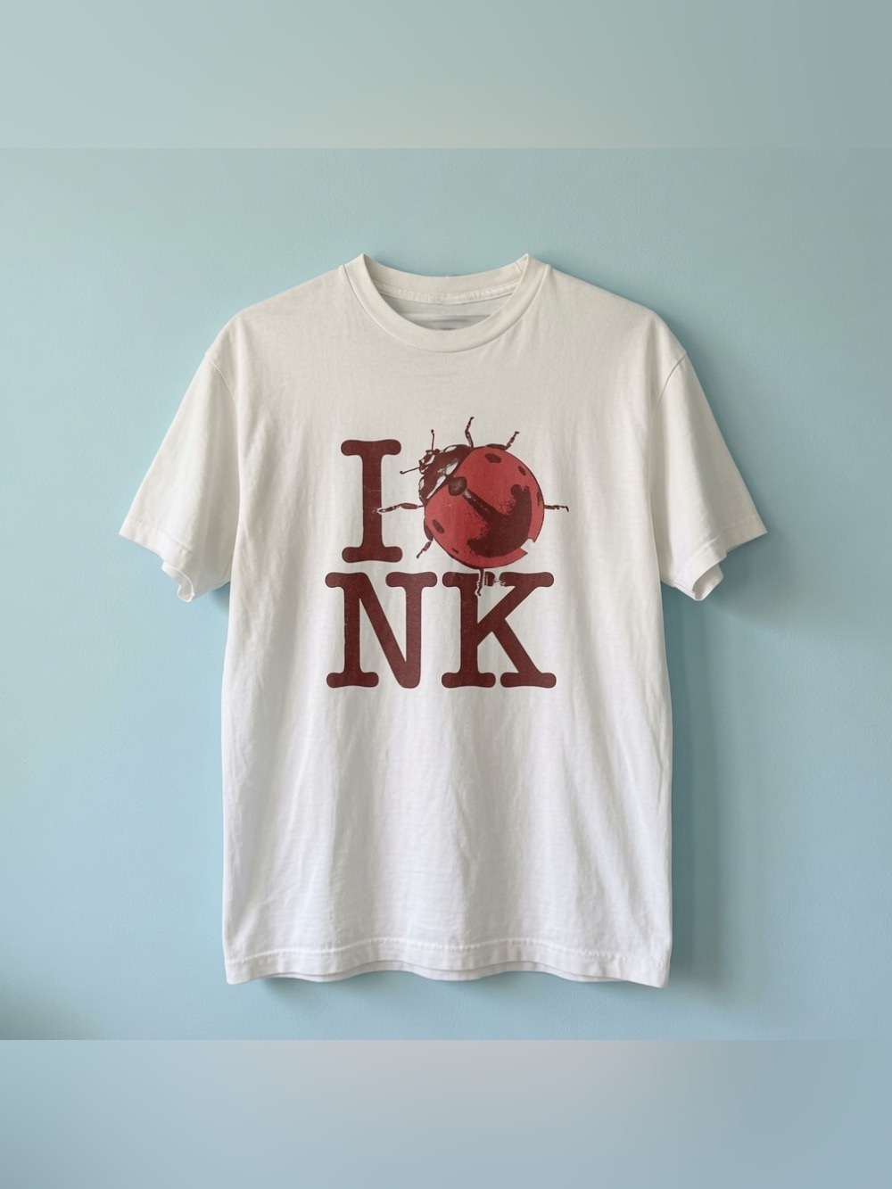 NK White Graphic Tee with Red Ladybug - Picture 1 of 5